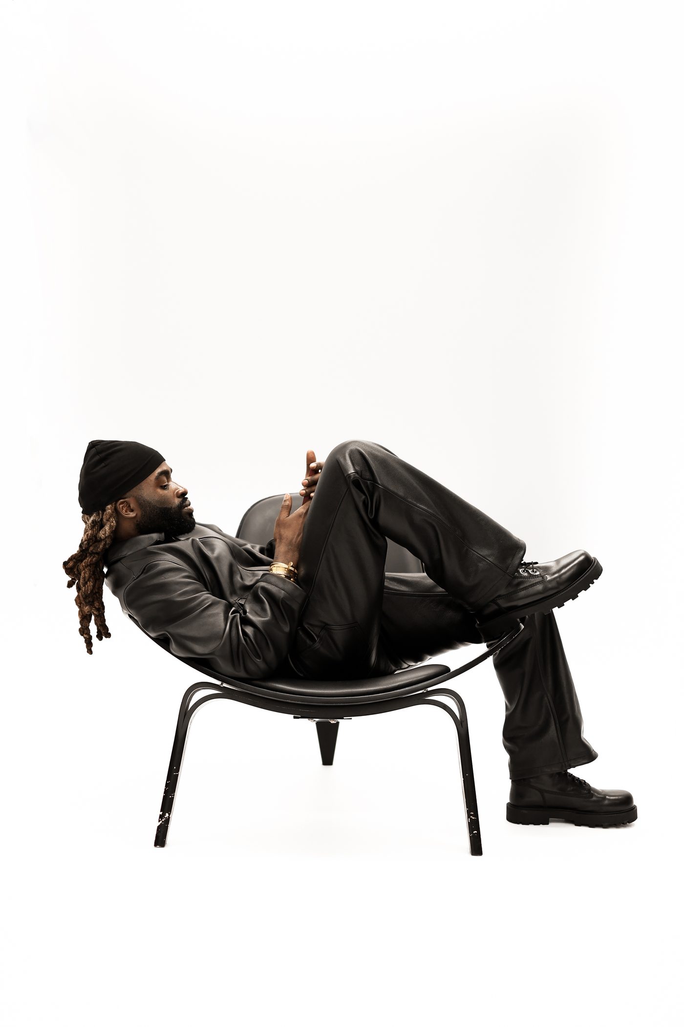 Model reclined in Noir jacket and Workman pant, side profile