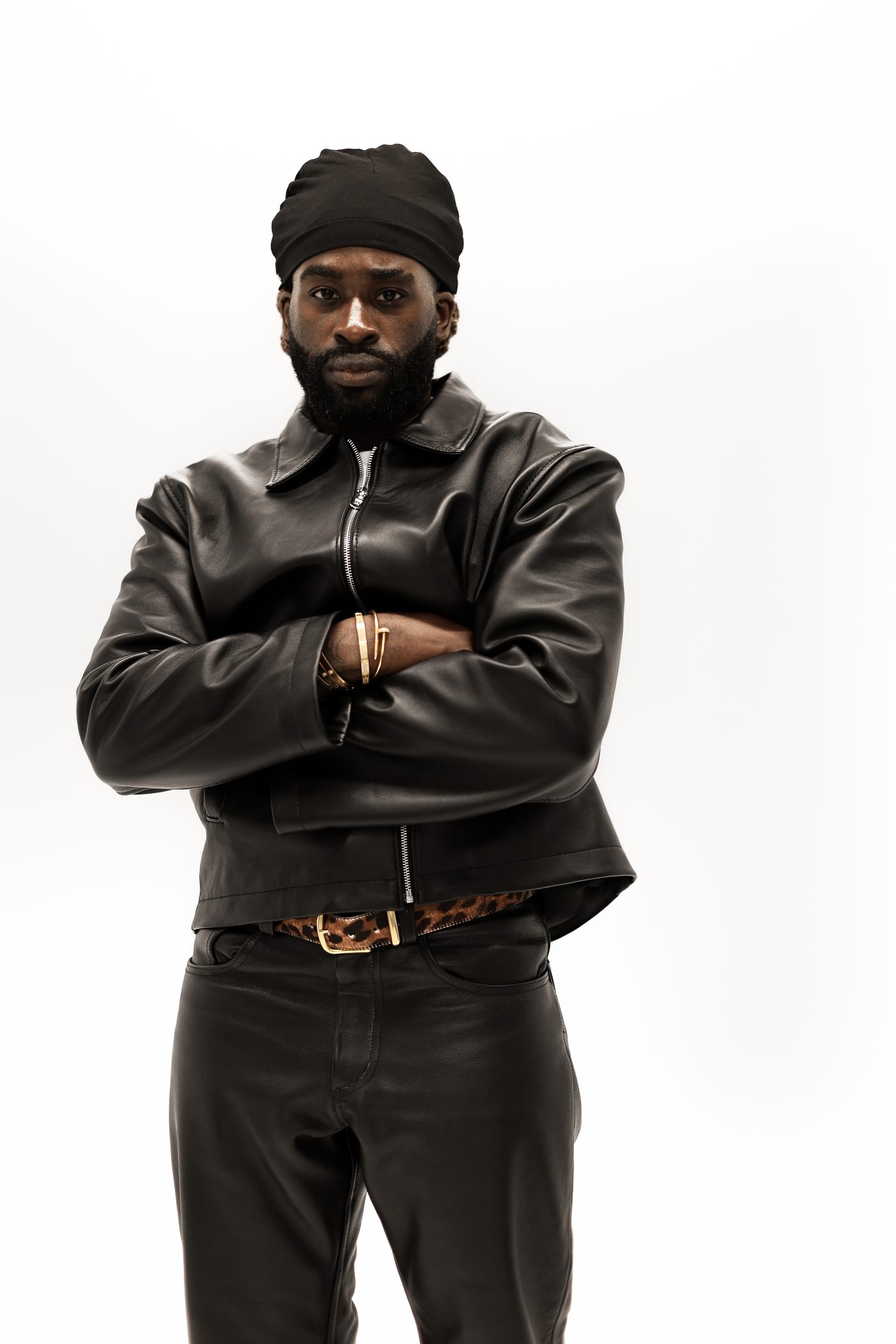 Model wearing Noir jacket, arms crossed, front view
